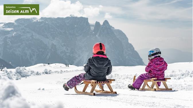 Tobogganing and sledding on the Seiser Alm in the Dolomites