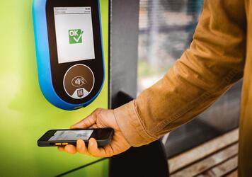 A man is scanning his ticket