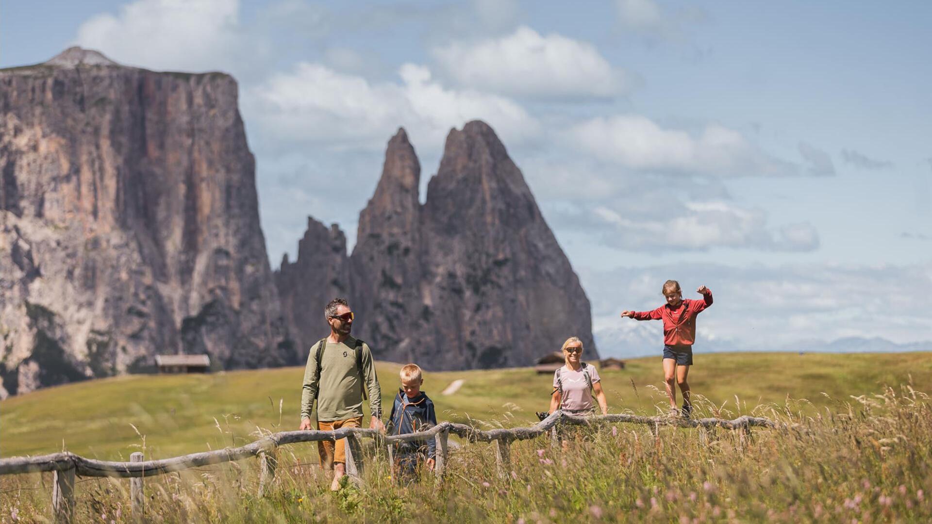 A family with two children hiking on Seiser Alm