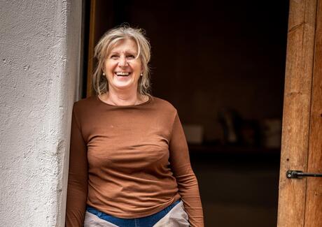 A woman is leaning against a door