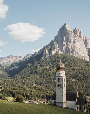 Parish church of Seis am Schlern, with the Dolomites in the background
