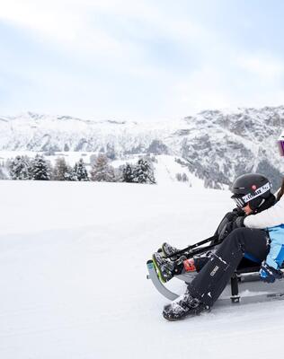A woman and a child sledding