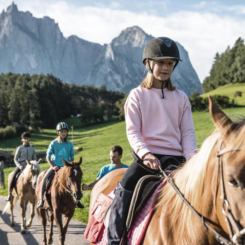 Children ride horses