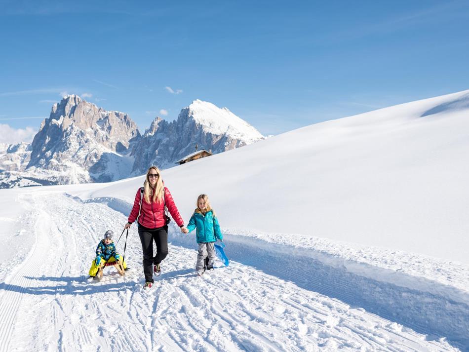 Sledding on the largest high alpine pasture in Europe the Seiser Alm in the Dolomites